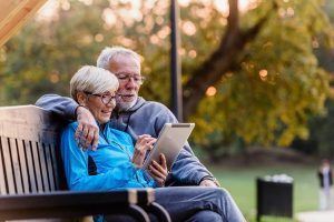 Smiling senior active couple sitting on the bench