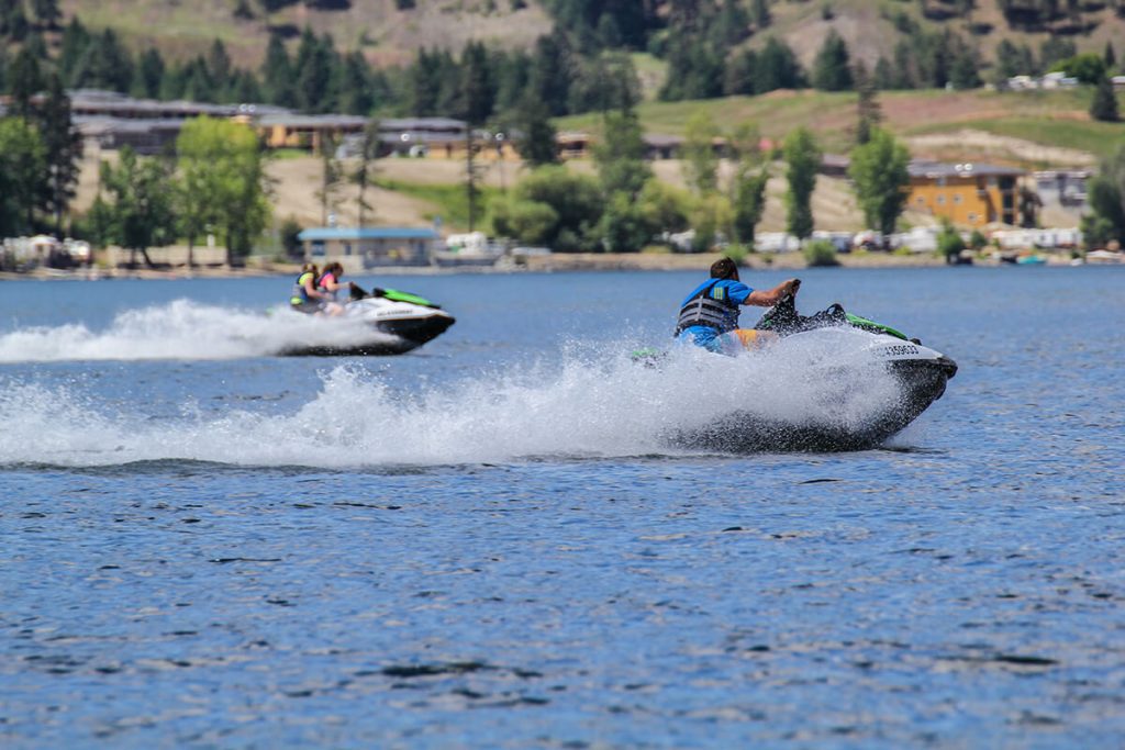 Two couple on speed boats jet ski