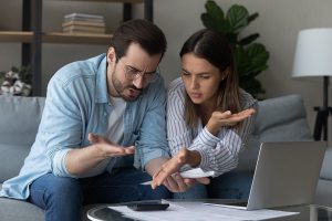 family couple calculating domestic expenses