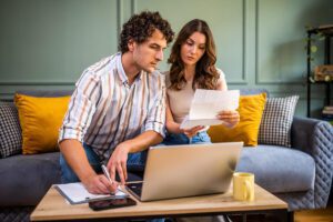 Couple discussing home finance while checking bills