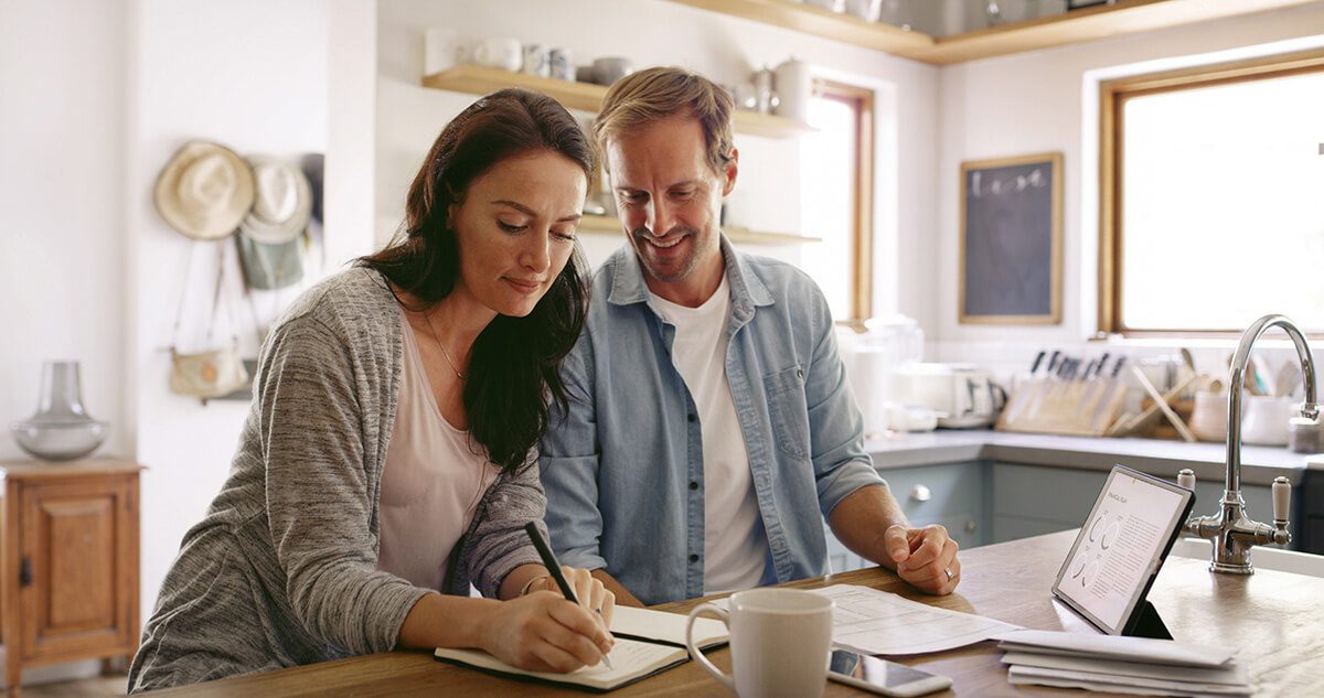 Finance, notebook and couple in home for writing