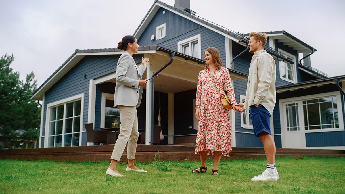 Realtor Showing a Hot Property Location to a Young Successful Couple