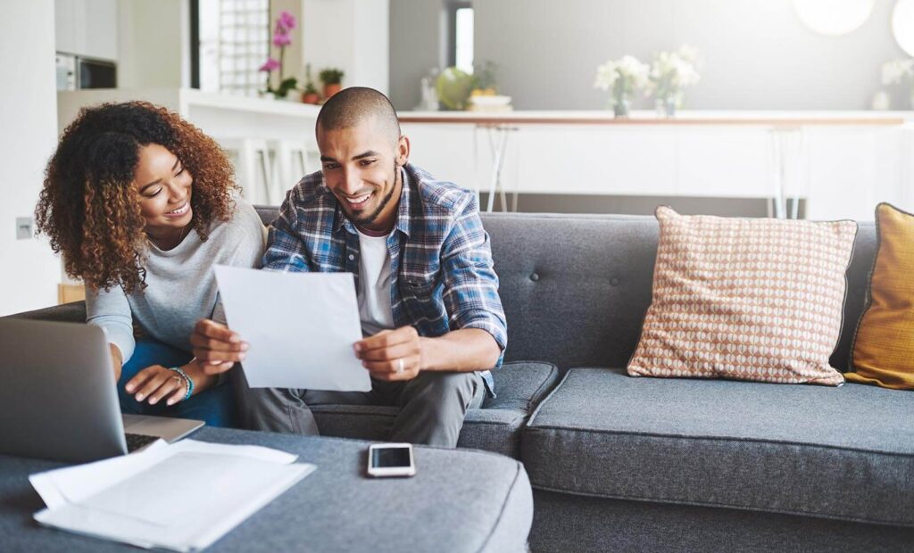 Young couple going through their paperwork together at home