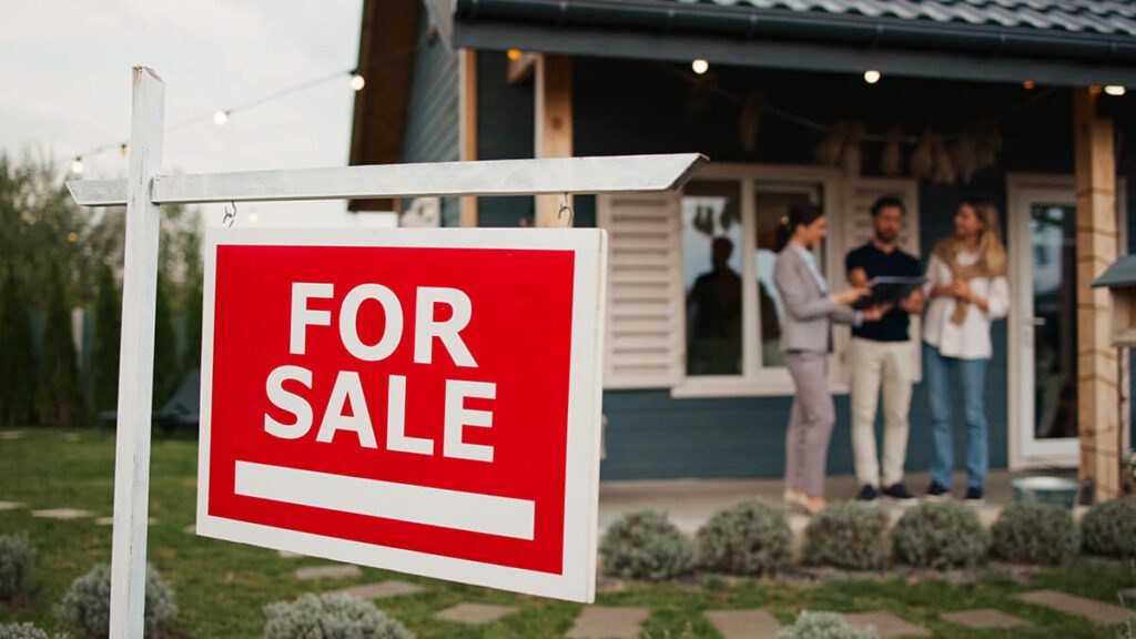 sign hanging in front of entrance to house