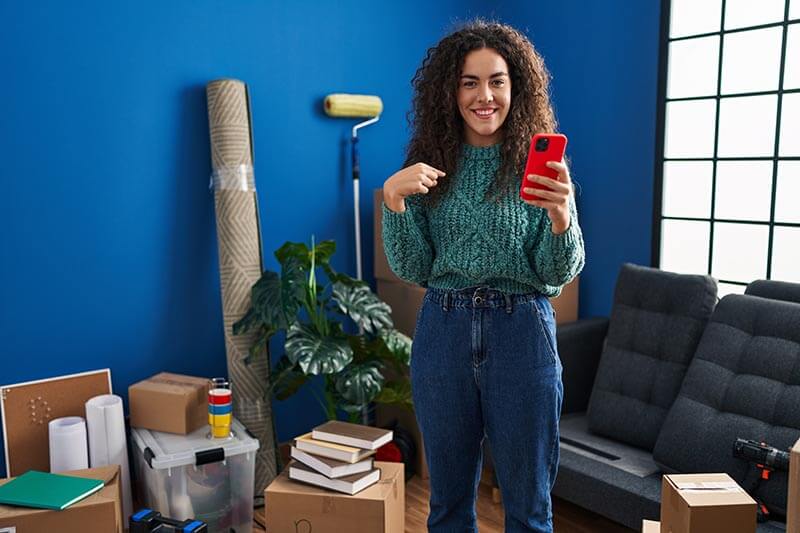 woman at new home using smartphone