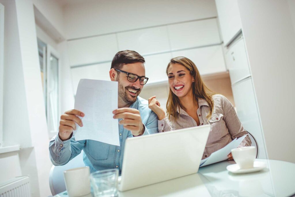 young-couple-using-a-laptop-while-going-over-their-finances-at-home